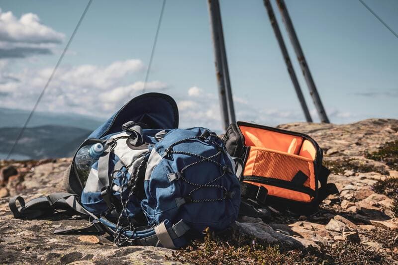 Photo of backpack on top of a mountain.