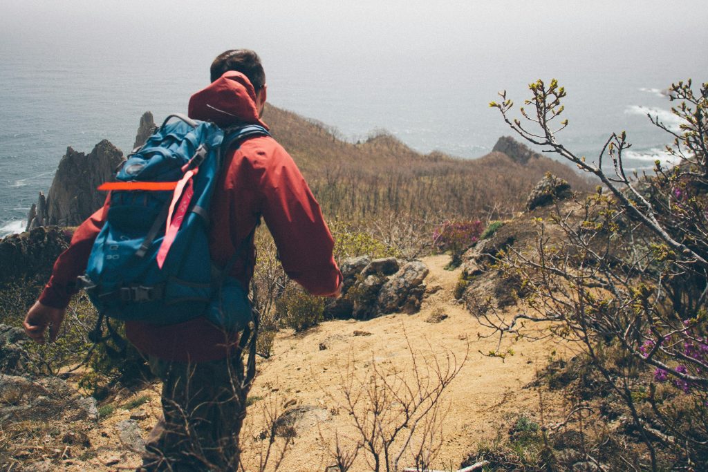 A hiker carrying his hiking gear