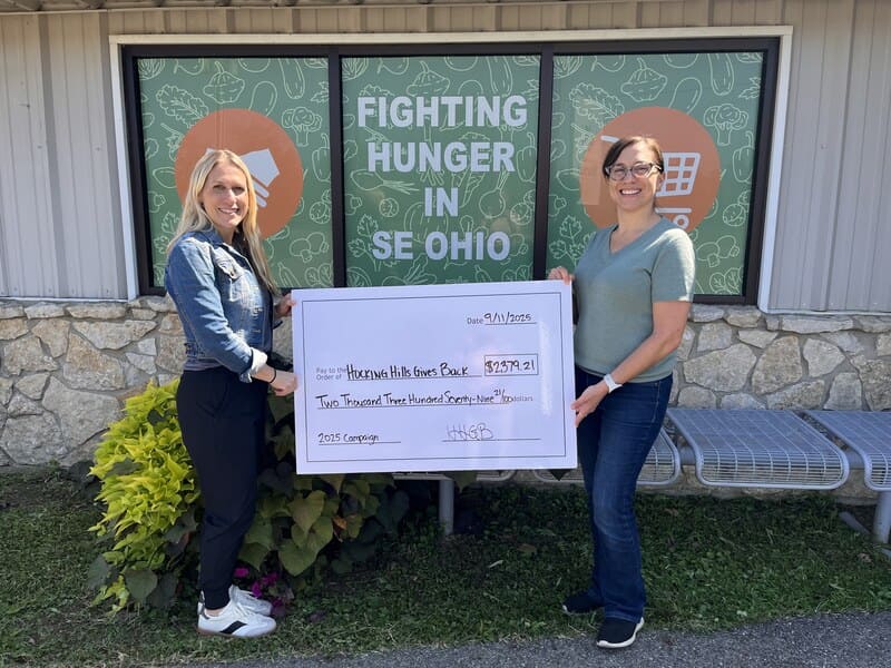 Debbie Todd handing over their Hocking Hills Give Back proceeds to Fighting Hunger in SE Ohio during their 2025 Campaign.